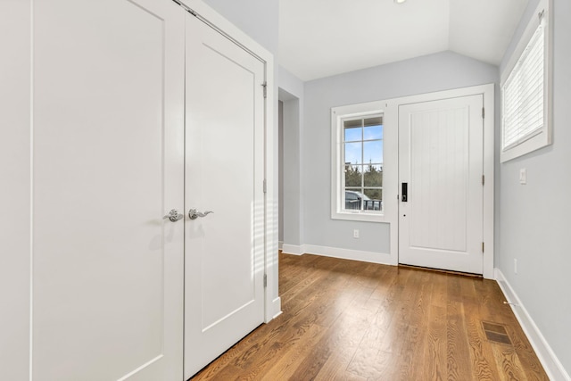 entrance foyer featuring lofted ceiling and light wood-type flooring