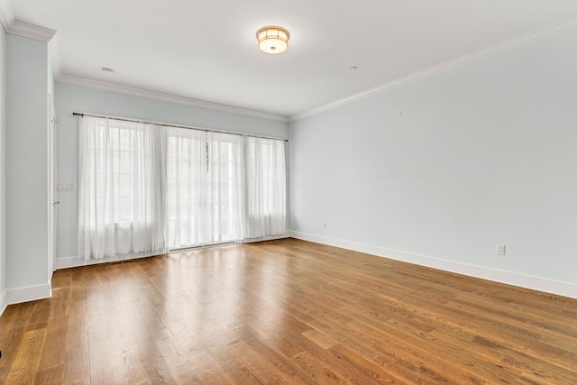 unfurnished room featuring hardwood / wood-style flooring and crown molding