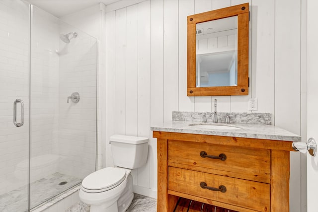 bathroom with vanity, a shower with shower door, and toilet