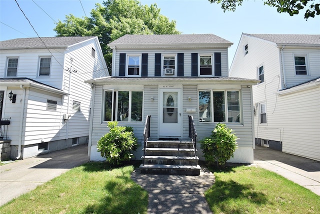 view of front of home featuring entry steps and a front yard