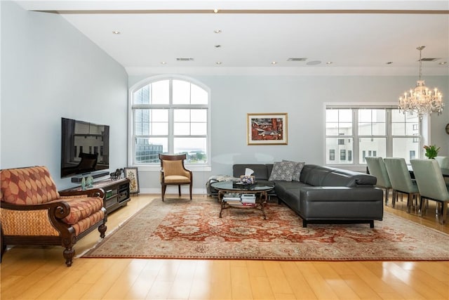 living room with wood-type flooring and a chandelier