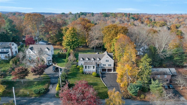 birds eye view of property with a view of trees