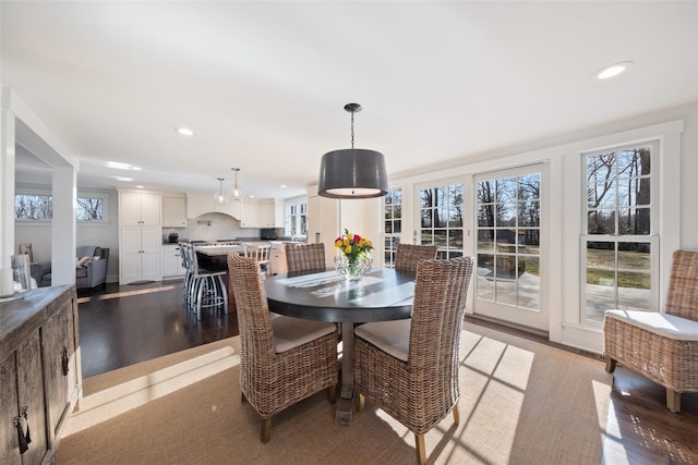 dining area featuring wood finished floors and recessed lighting