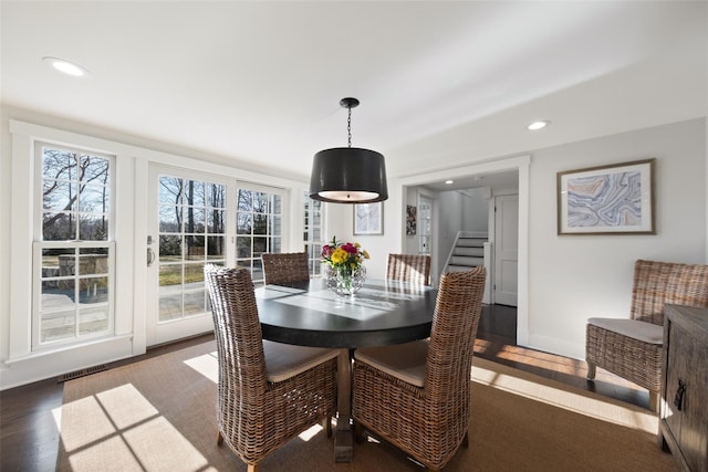 dining space featuring baseboards, visible vents, wood finished floors, stairs, and recessed lighting