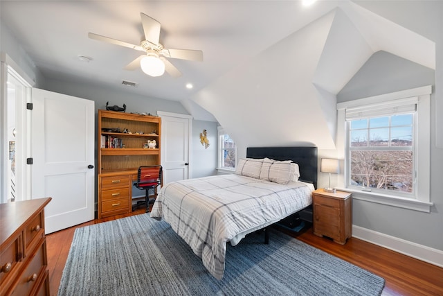 bedroom featuring lofted ceiling, wood finished floors, visible vents, and baseboards