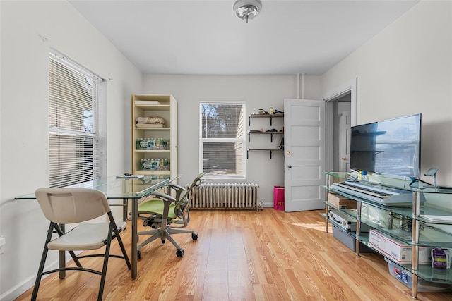 office featuring radiator and light hardwood / wood-style flooring