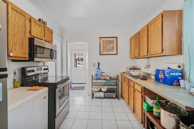 kitchen featuring light tile patterned floors, ornamental molding, stainless steel appliances, and sink