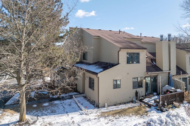 view of snow covered rear of property