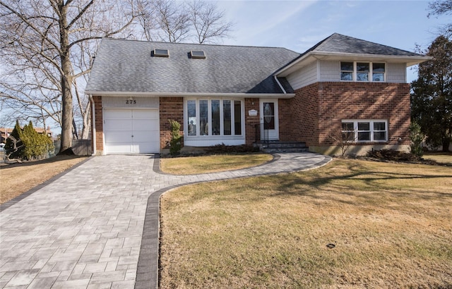 tri-level home with a front lawn and a garage