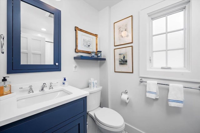 full bath with baseboards, vanity, and toilet