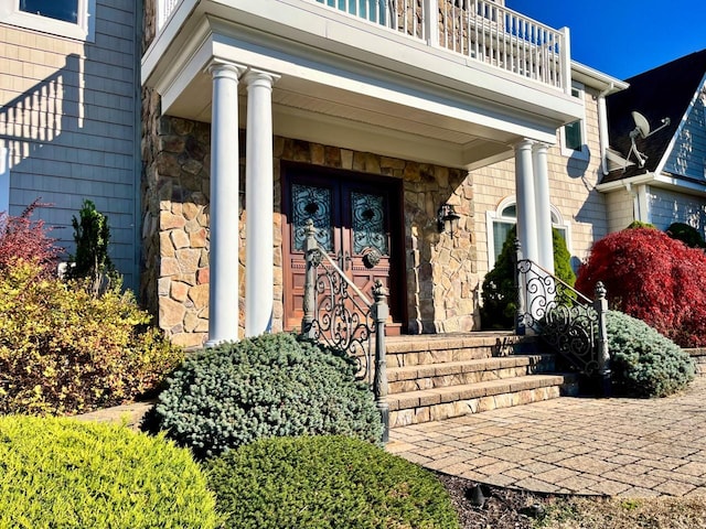 view of exterior entry featuring stone siding