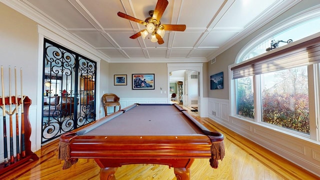 recreation room featuring wood finished floors, a wainscoted wall, visible vents, a ceiling fan, and arched walkways