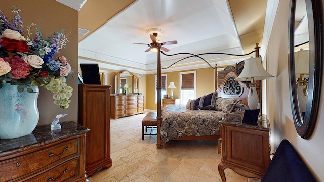 bedroom with crown molding, stone finish floor, visible vents, and a raised ceiling