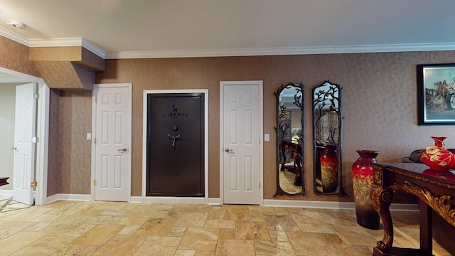 foyer entrance with stone tile floors, baseboards, and ornamental molding