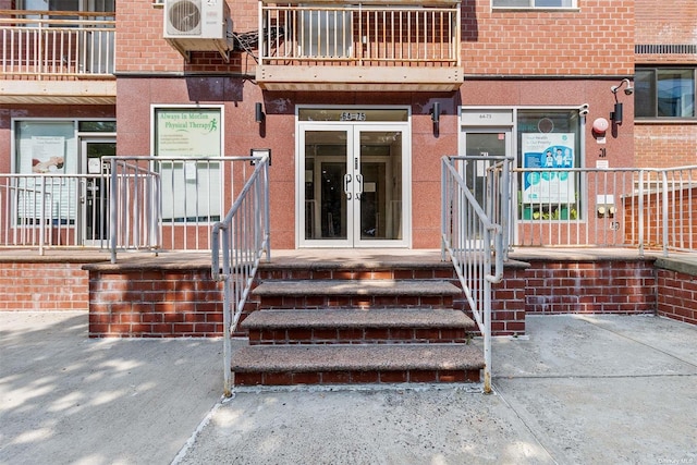 entrance to property featuring ac unit and french doors