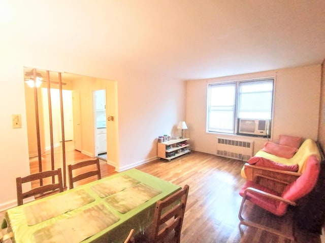 interior space with radiator, hardwood / wood-style floors, and cooling unit