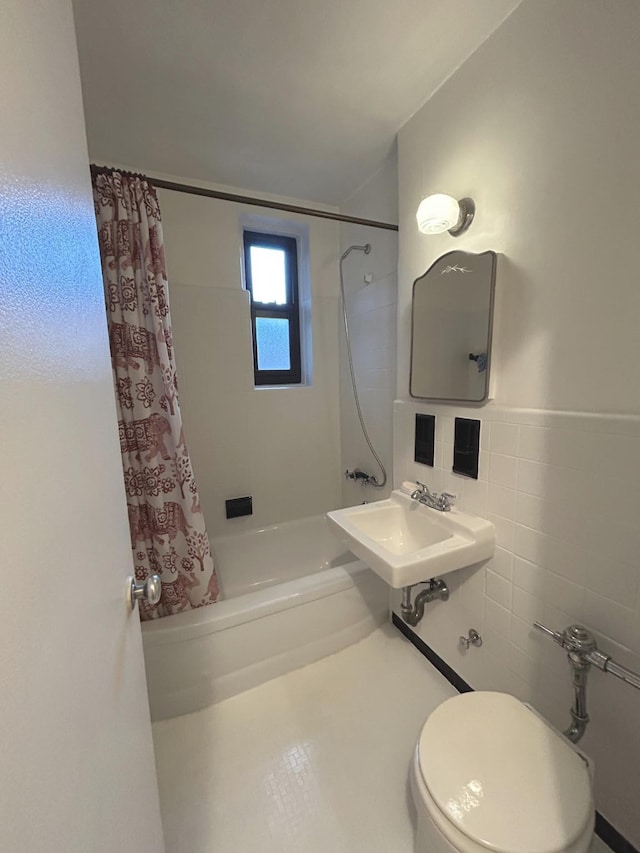 full bathroom featuring toilet, sink, tile walls, and shower / bath combo with shower curtain