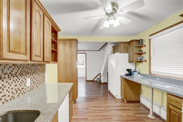 kitchen featuring white appliances, decorative backsplash, a baseboard heating unit, open shelves, and built in desk