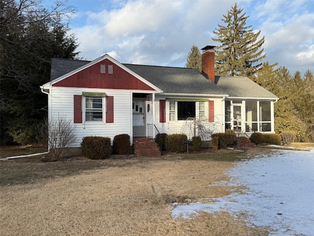 single story home with a yard and a sunroom