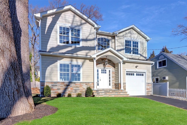 view of front of property with a garage and a front yard