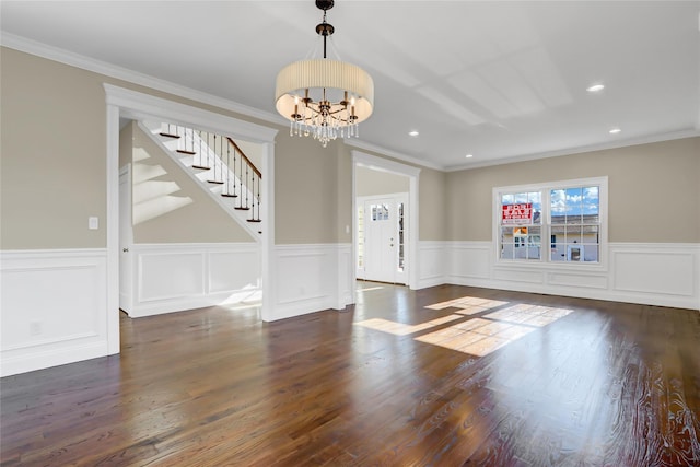 interior space with a notable chandelier, crown molding, and dark hardwood / wood-style floors