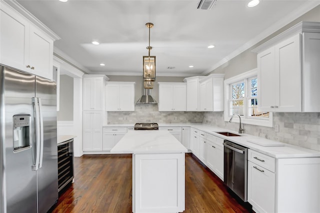 kitchen with sink, a center island, white cabinets, and appliances with stainless steel finishes