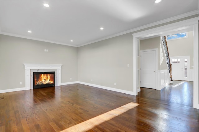 unfurnished living room featuring dark wood-type flooring and ornamental molding