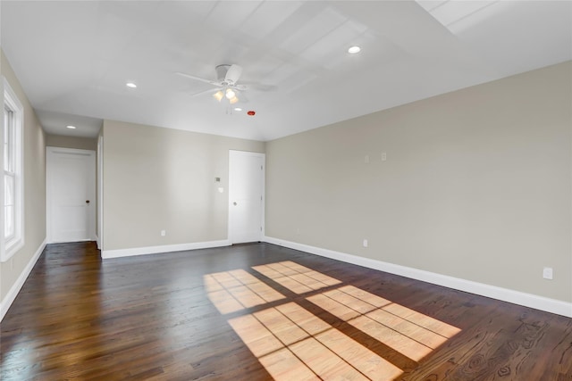 empty room featuring dark wood-type flooring and ceiling fan