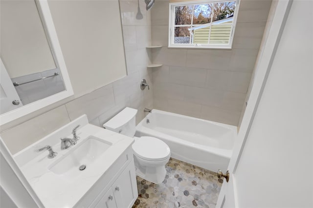 full bathroom with tiled shower / bath, vanity, toilet, and tile walls