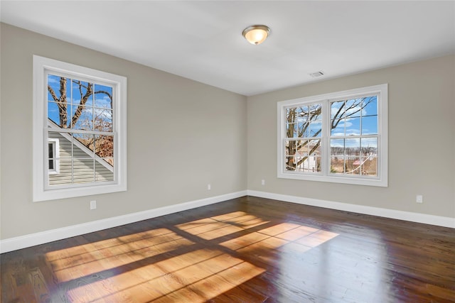 spare room featuring dark hardwood / wood-style flooring