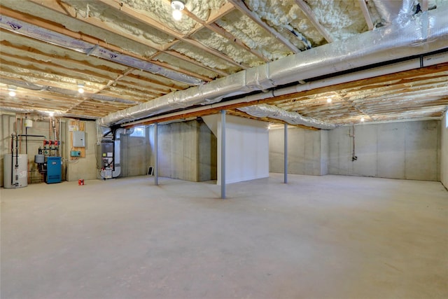 basement with heating unit, electric panel, and water heater