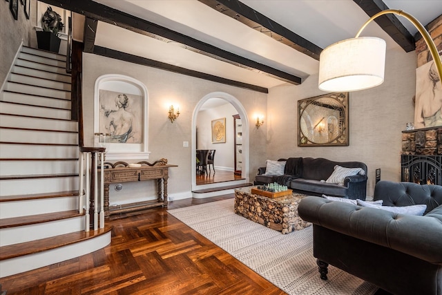 living room with beam ceiling and dark parquet floors