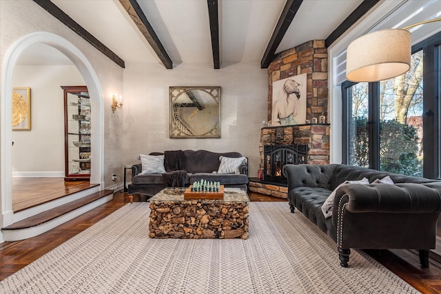 living room with beam ceiling, parquet flooring, and a fireplace