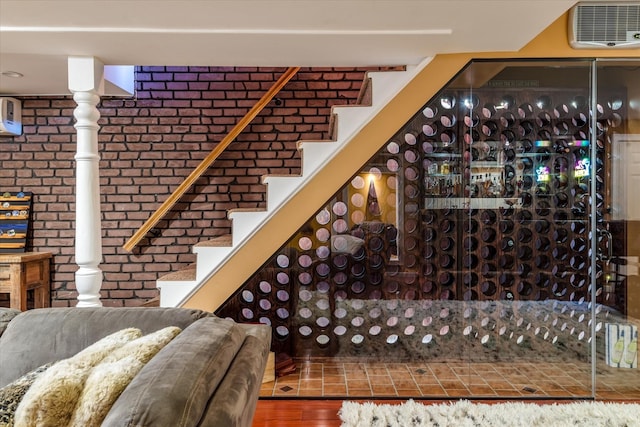 interior space featuring brick wall and wood-type flooring