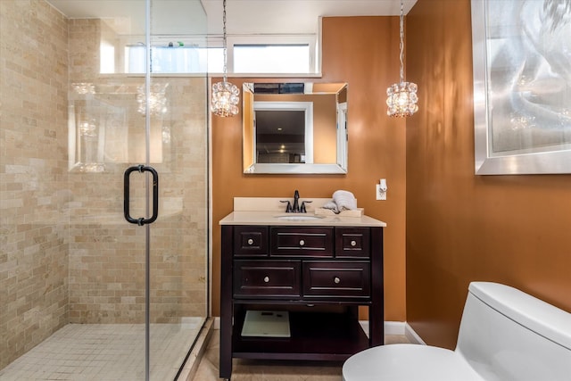 bathroom featuring vanity, a wealth of natural light, an enclosed shower, and toilet