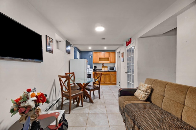 living room featuring light tile patterned floors and baseboard heating