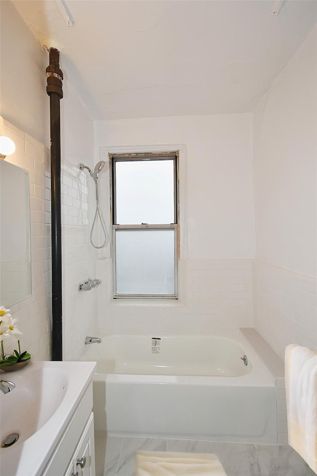 bathroom featuring bathing tub / shower combination, marble finish floor, and vanity