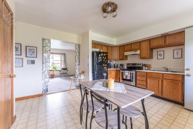 kitchen featuring stainless steel electric range, sink, and black refrigerator