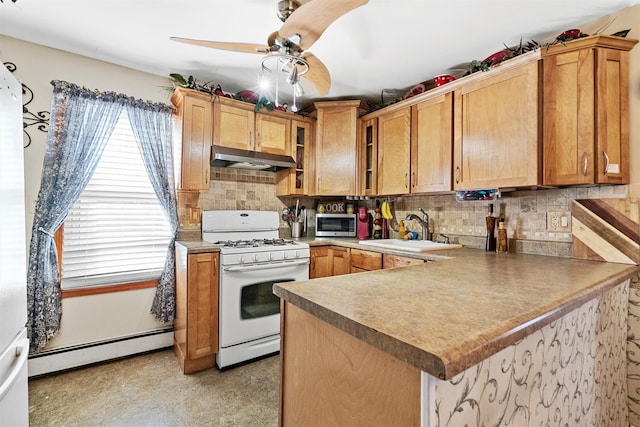 kitchen featuring sink, a baseboard heating unit, white gas range oven, and kitchen peninsula