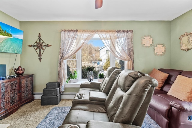 carpeted living room featuring ceiling fan and a baseboard heating unit