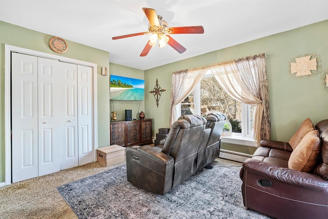 interior space with baseboard heating, ceiling fan, and carpet flooring