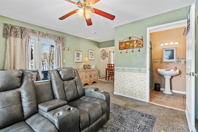 interior space featuring ceiling fan, sink, and a baseboard heating unit