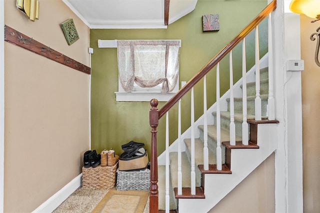 stairs featuring crown molding