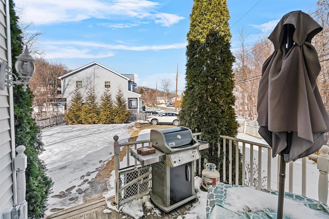 snow covered patio featuring area for grilling