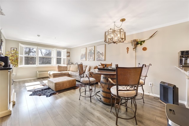 dining room with baseboards, wood finished floors, and crown molding