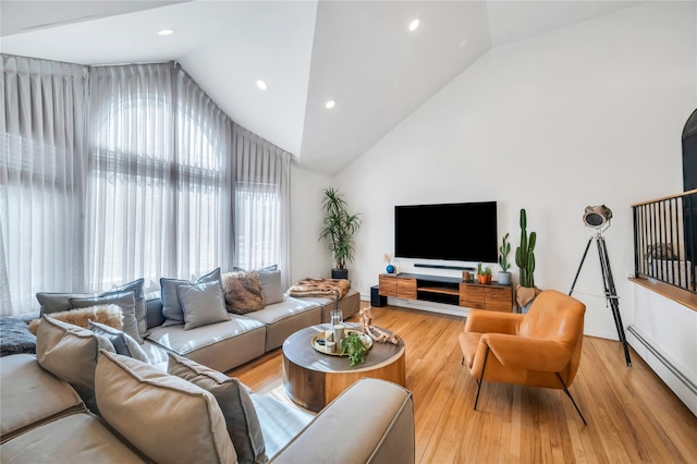 living area with high vaulted ceiling, recessed lighting, a baseboard radiator, and light wood-style floors