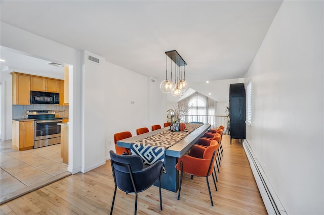 dining area with light wood-type flooring, visible vents, baseboard heating, and a notable chandelier