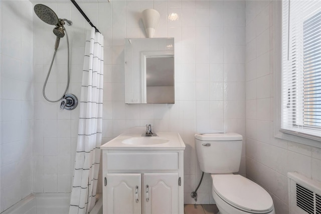 full bath featuring tile walls, radiator heating unit, toilet, vanity, and tiled shower