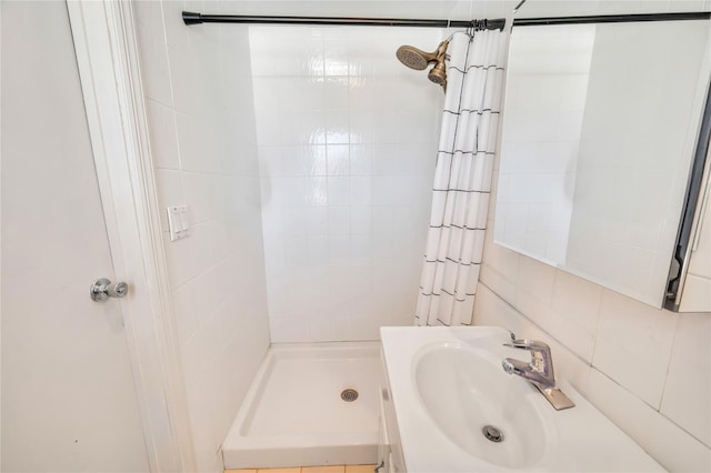 bathroom featuring a shower stall and a sink