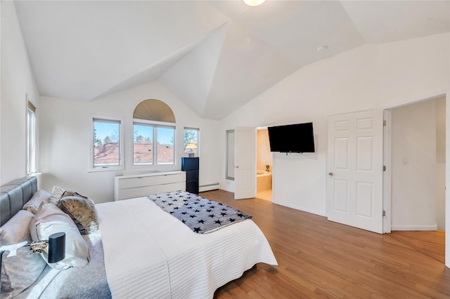 bedroom featuring baseboards, connected bathroom, lofted ceiling, wood finished floors, and baseboard heating